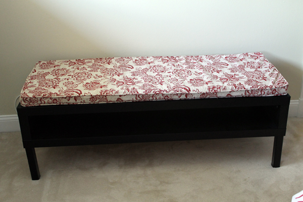 Former coffee table turned into bench with cushion.