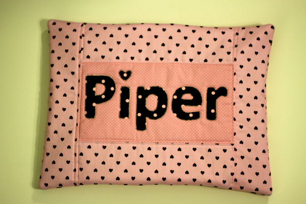 Piper's name pillow with brown hearts
